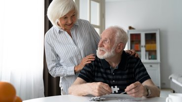 Casal idoso monta quebra-cabeças
